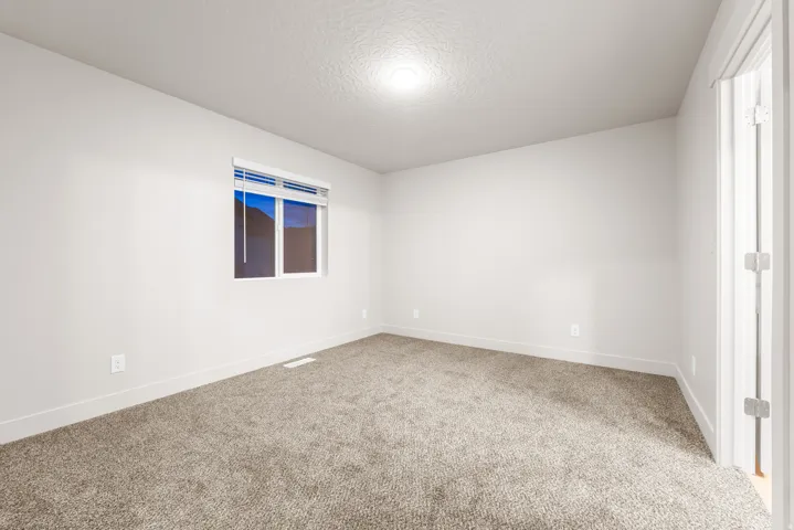 Neutral wall finishes, recessed lighting, white window blinds, and carpeted flooring