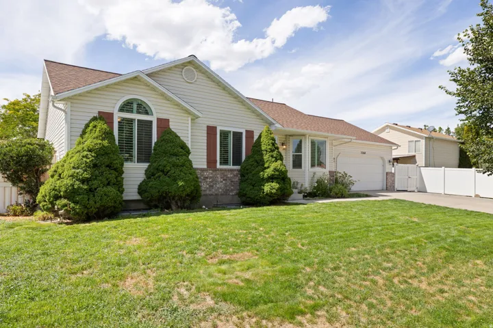 Light-colored siding exterior with a brown shingled roof