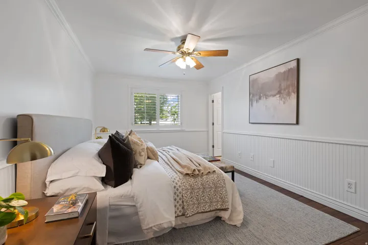 Hardwood-style flooring with crown molding and wainscoting