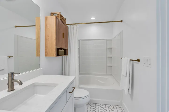 White vanity with an integrated sink and bronze-finish faucet