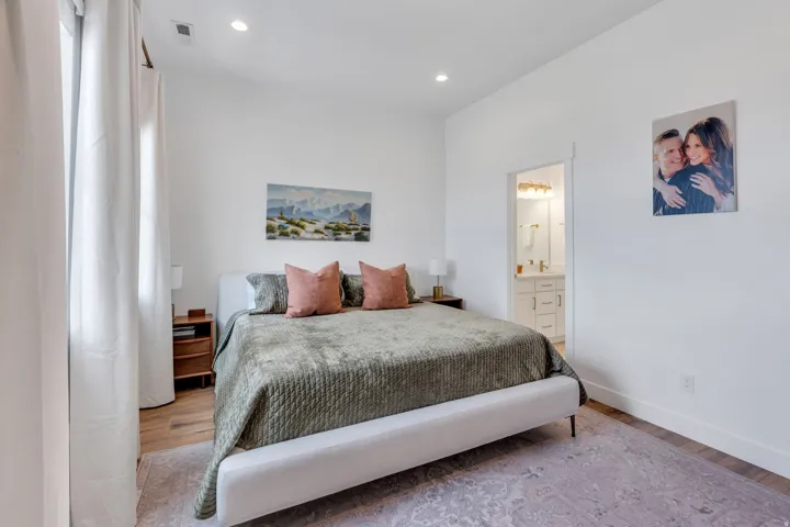 Recessed lighting illuminates wood-finish flooring