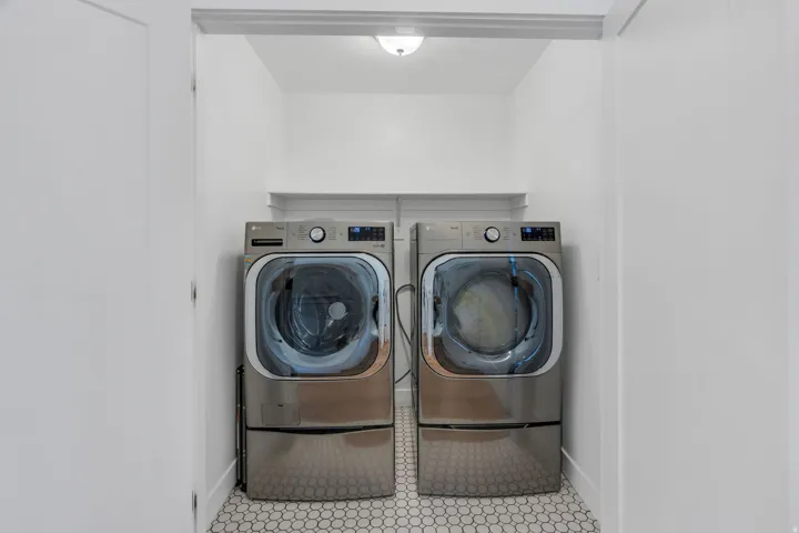 Dedicated laundry area with hexagon tile flooring and a built-in shelf
