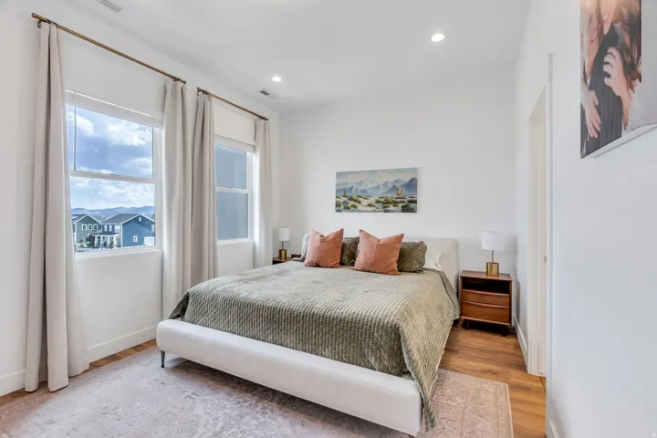 Recessed lighting, wood-finish flooring, and white walls