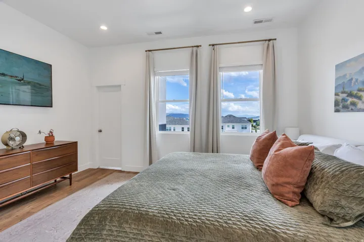 Recessed lighting, wood-finish flooring, and white walls