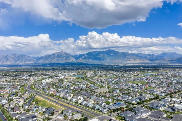 Expansive suburban development with established residential structures and a prominent mountain backdrop