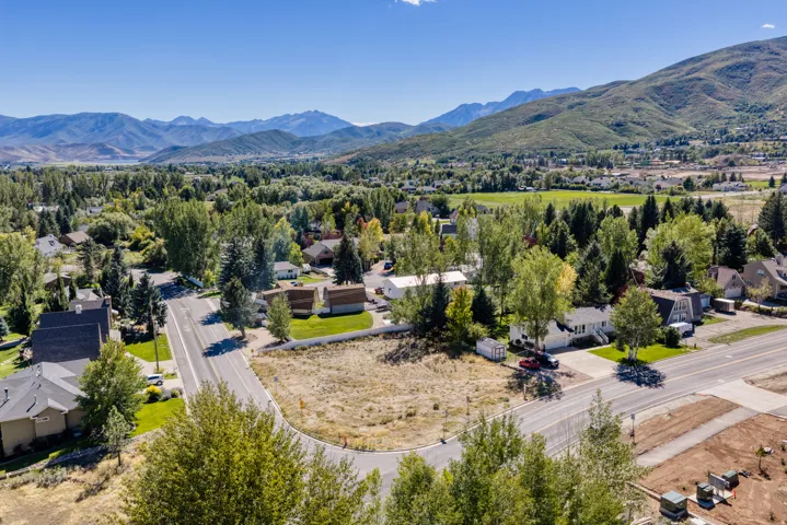 Expansive lot with established surrounding trees and paved road frontage