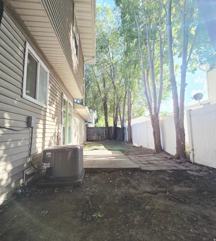 Patio area featuring a concrete slab and access to the interior through a sliding glass door