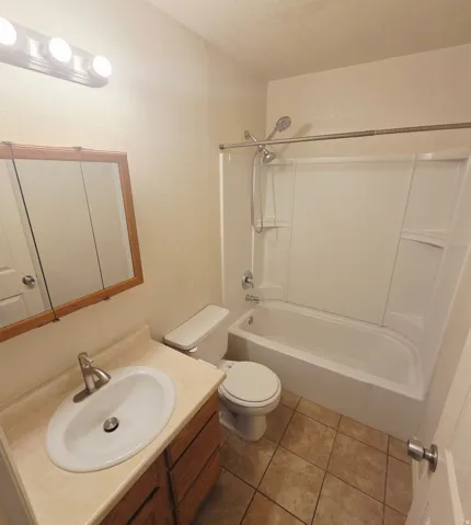 Vanity with integrated sink, wood-finish cabinetry, and brushed nickel faucet