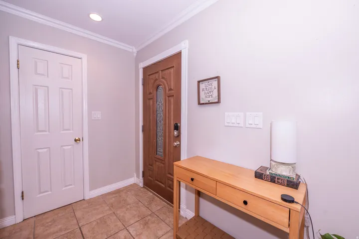 Warm wood-tone entry door with decorative glass inserts