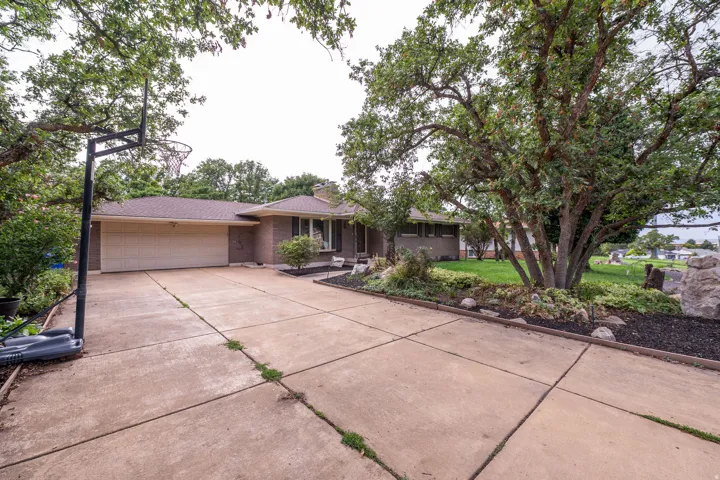 Brick exterior with a multi-car concrete driveway