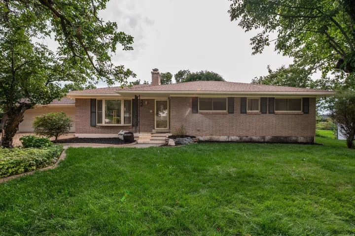 Brick exterior with a covered front entry and a bay window