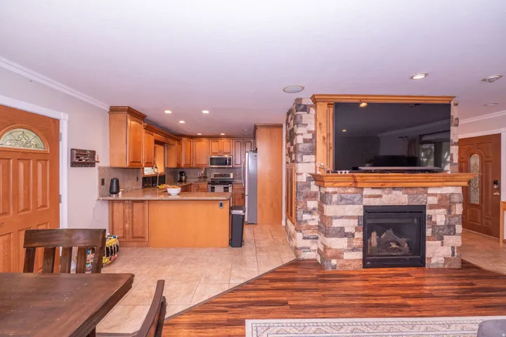 Kitchen featuring wood cabinetry, stone-look countertops, and stainless steel appliances