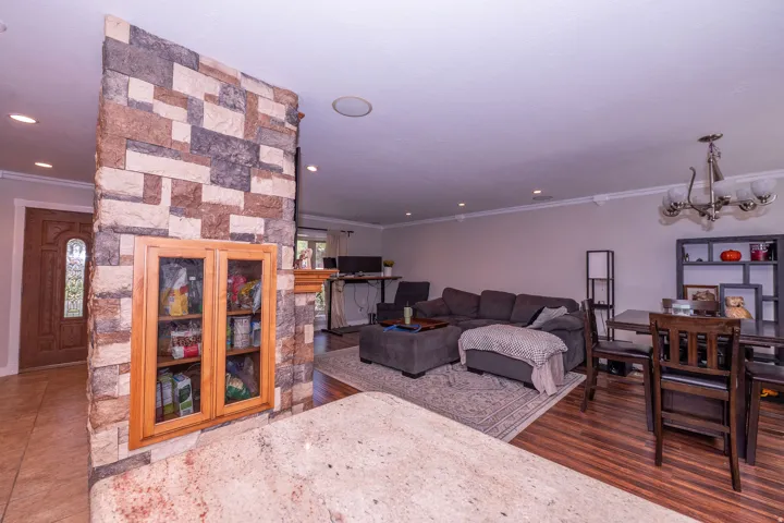 Wood-finish flooring throughout, complemented by crown molding and recessed lighting