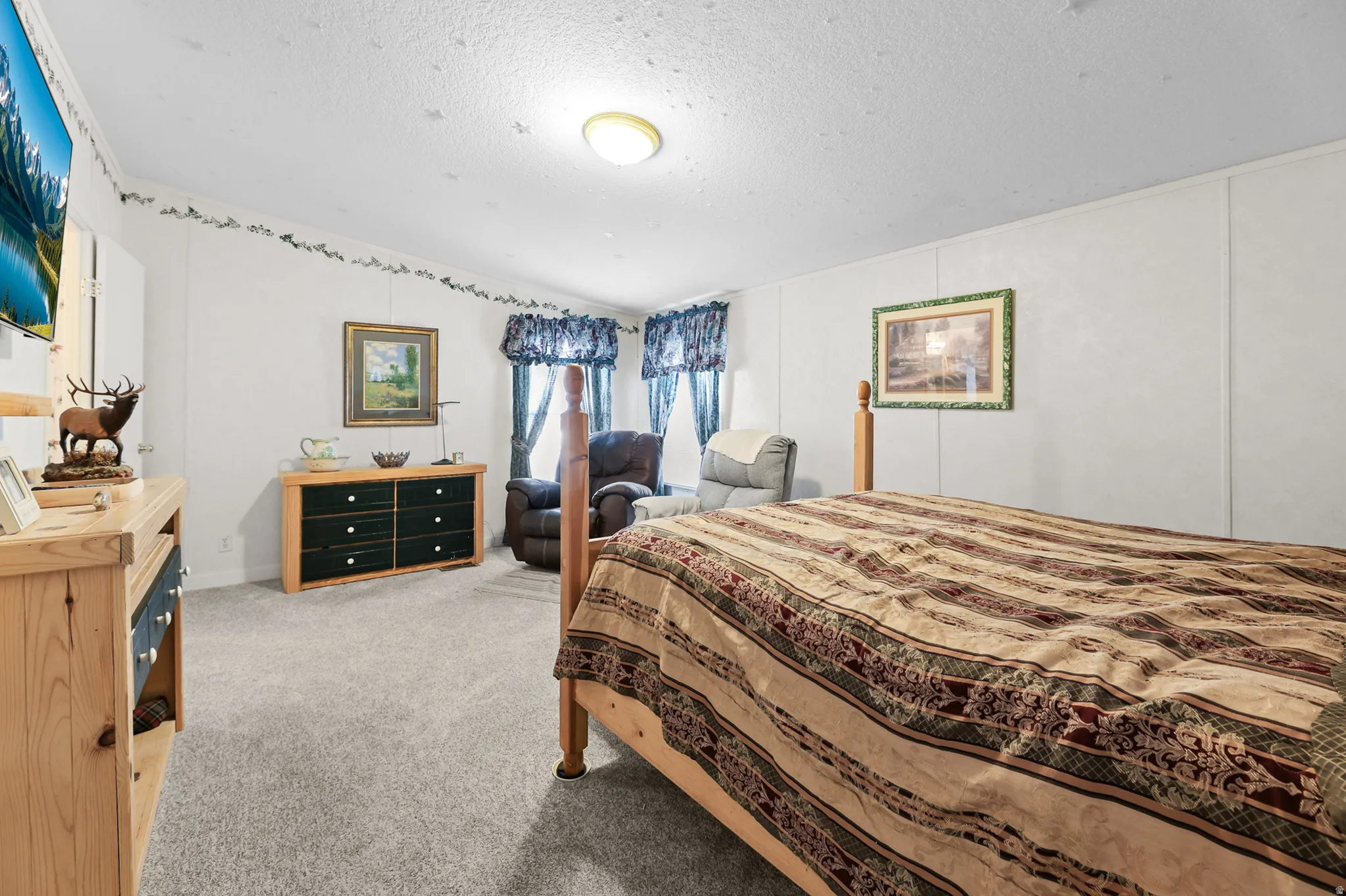 Wall-to-wall carpeting with a neutral finish, light-toned walls, and a ceiling-mounted light fixture