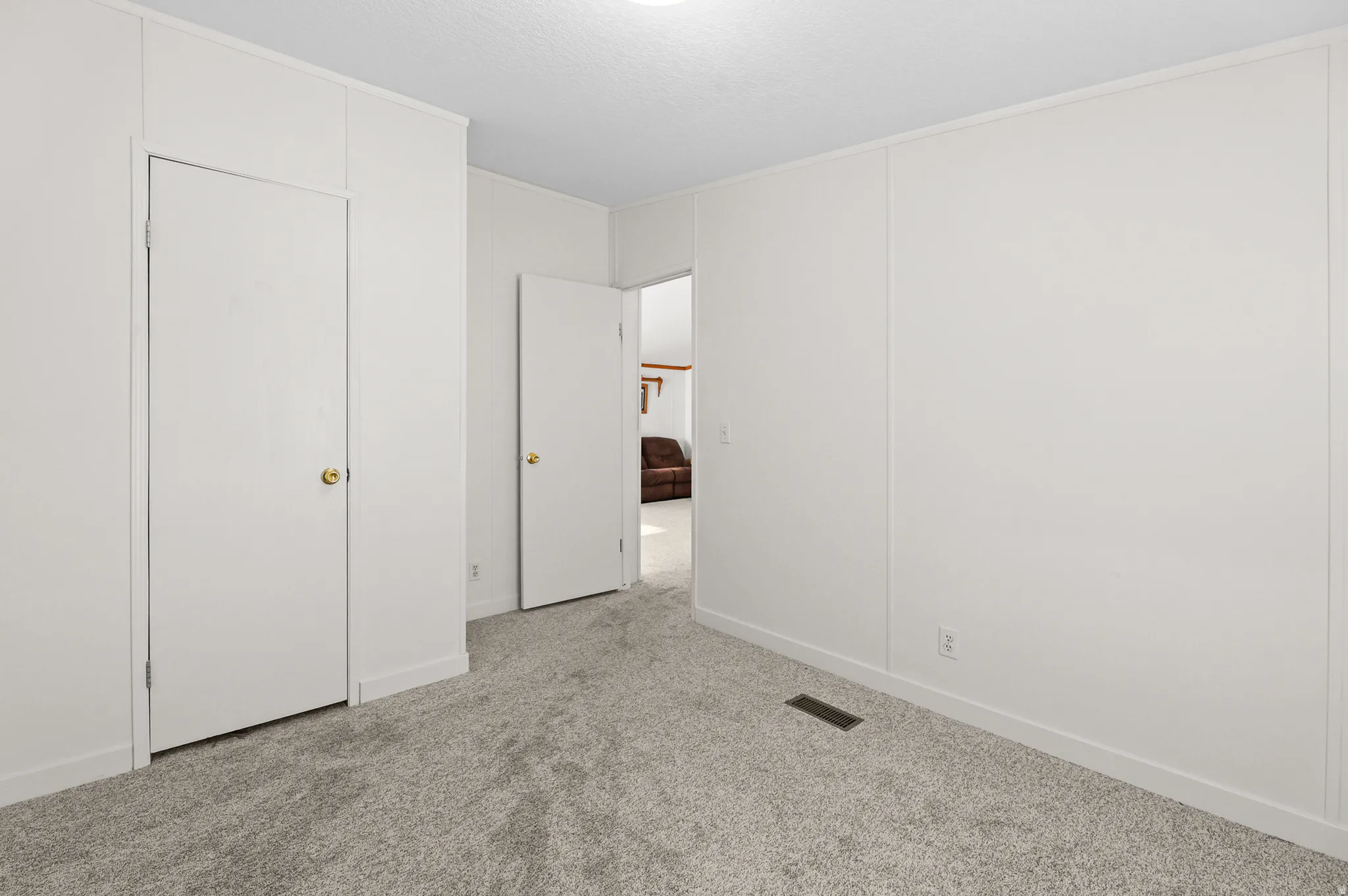 Neutral wall finishes, recessed lighting, wall-to-wall carpeting, and white trim accents