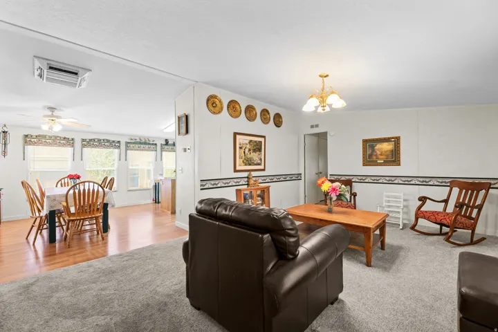 Open concept living area with carpeted flooring