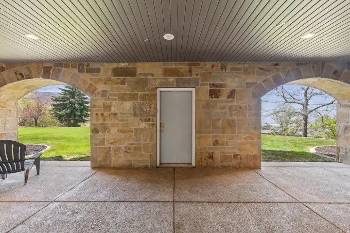 Covered patio with stone archways, recessed lighting, and a concrete surface
