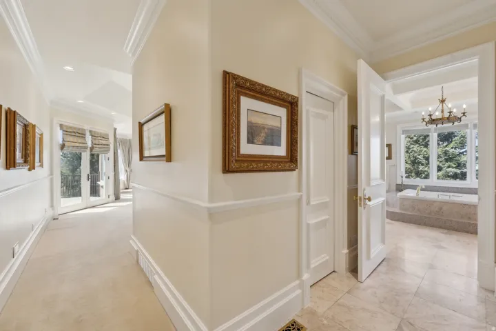 Hallway with crown molding, wainscoting, and recessed lighting