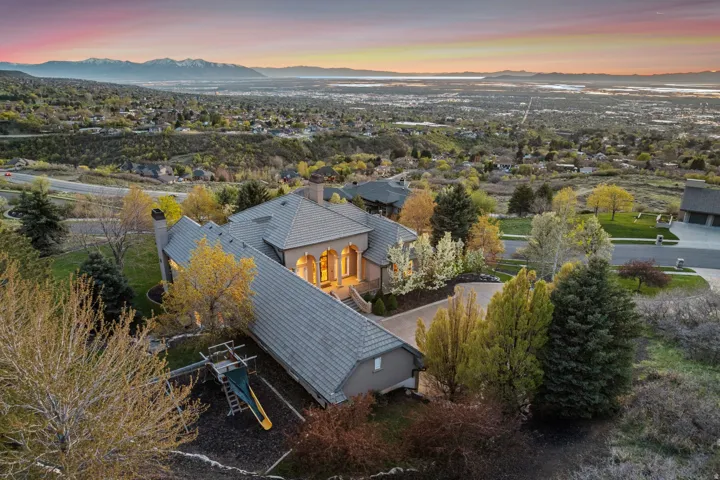 Expansive property featuring a multi-level structure, a terraced landscape, and mature trees