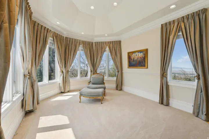 Recessed lighting, vaulted ceiling, crown molding, multiple windows, and extensive carpeting