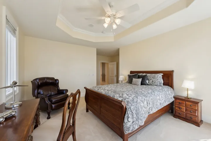 Tray ceiling with crown molding and a ceiling fan