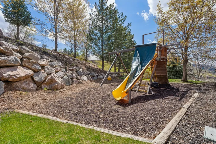 Terraced landscaping featuring a stone retaining wall