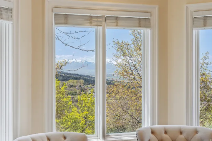 Bay window with multiple panes, featuring a mountain and valley backdrop