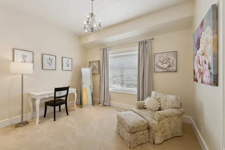 Recessed lighting, chandelier, window with blinds, light-colored carpeting, and light-colored walls