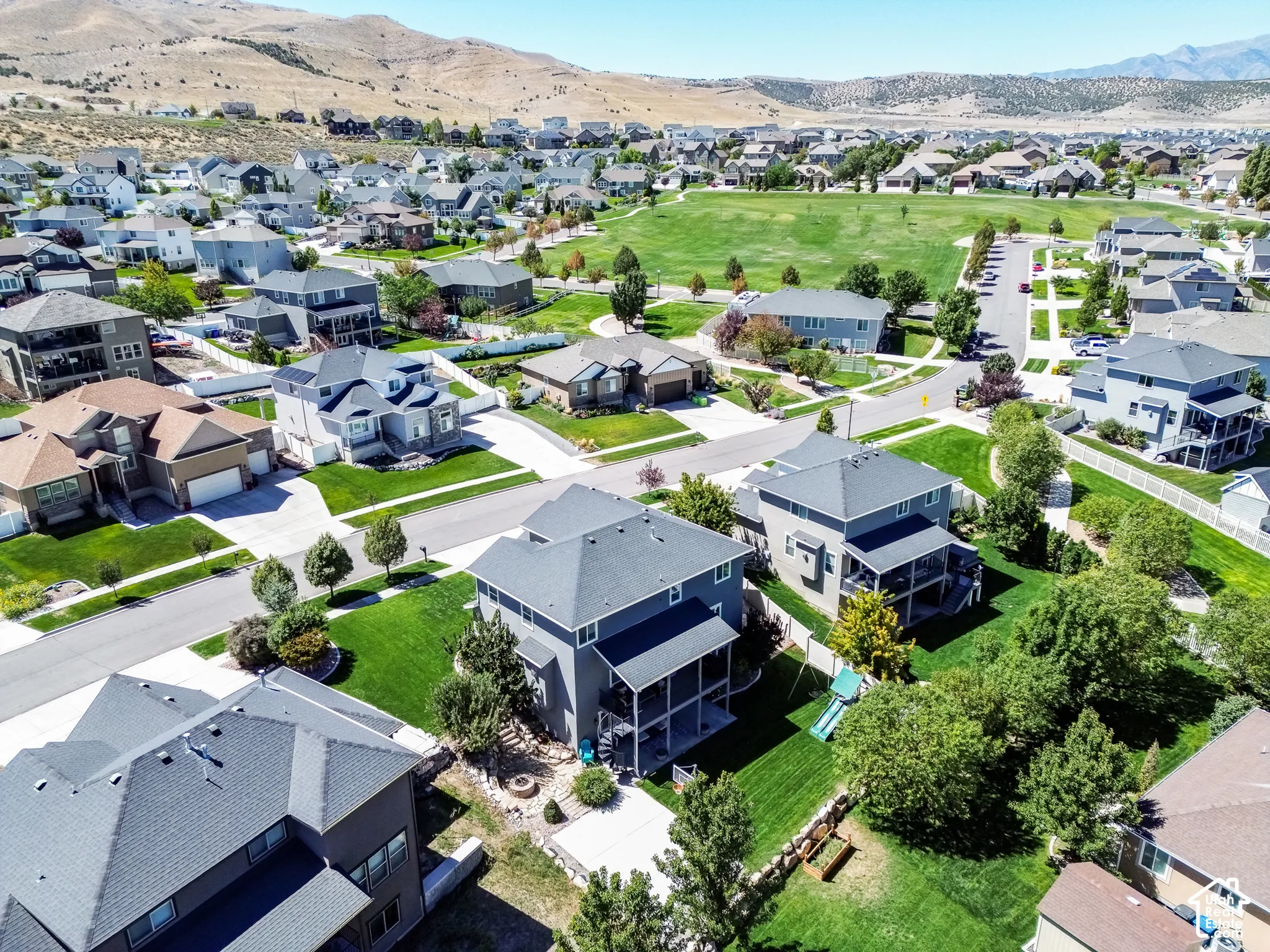Expansive community with manicured green spaces and paved streets
