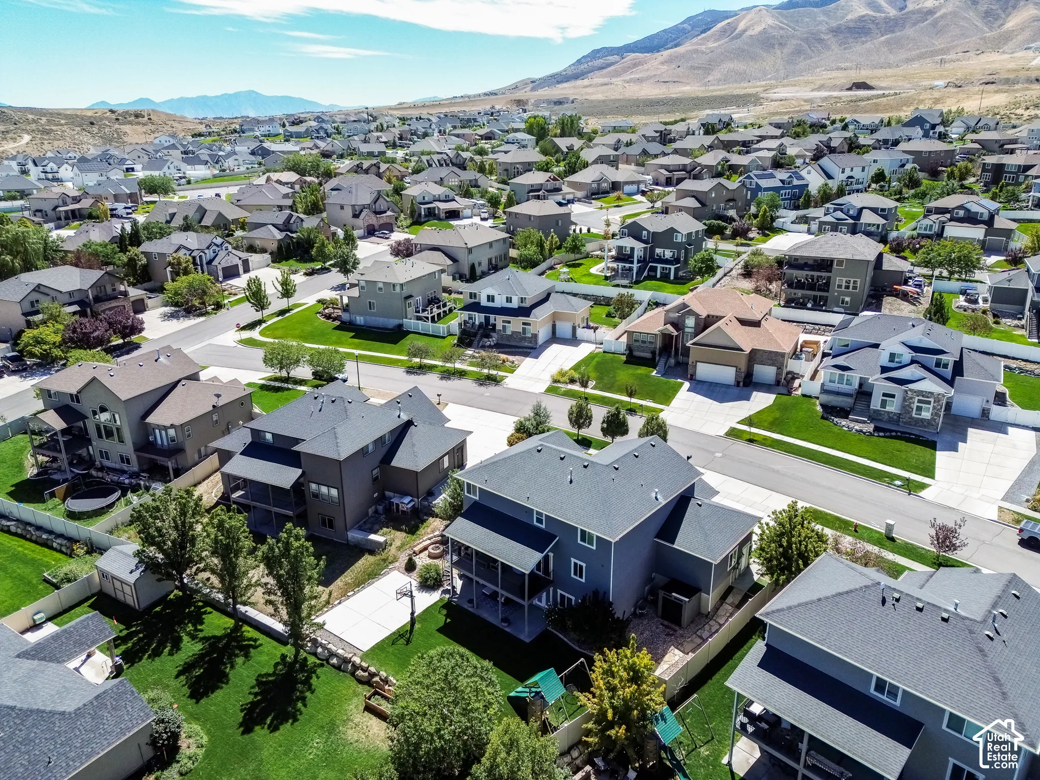 Residential neighborhood with varied architectural styles and mountain backdrop