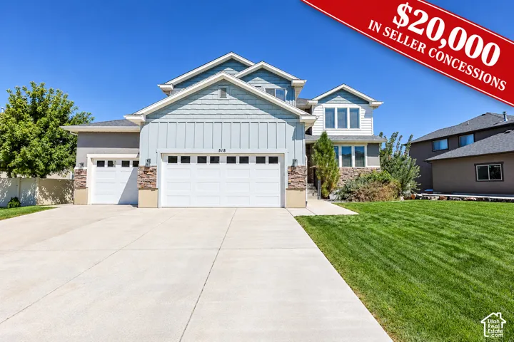 Gable roofline, mixed siding exterior, stone accents, two-car garage, and a concrete driveway