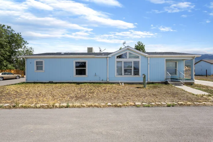Light blue exterior siding with a covered front entrance