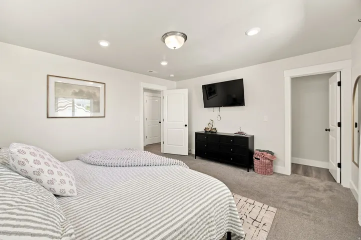 Recessed ceiling lighting, flush mount ceiling fixture, light gray wall paint, white trim, and carpeting