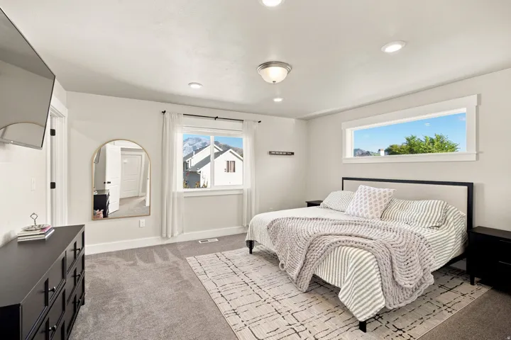 Recessed ceiling lighting, a rectangular window with white trim, and a window with white trim