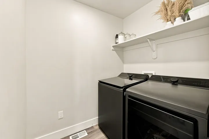 Dedicated laundry area with built-in shelving, providing practical storage solutions