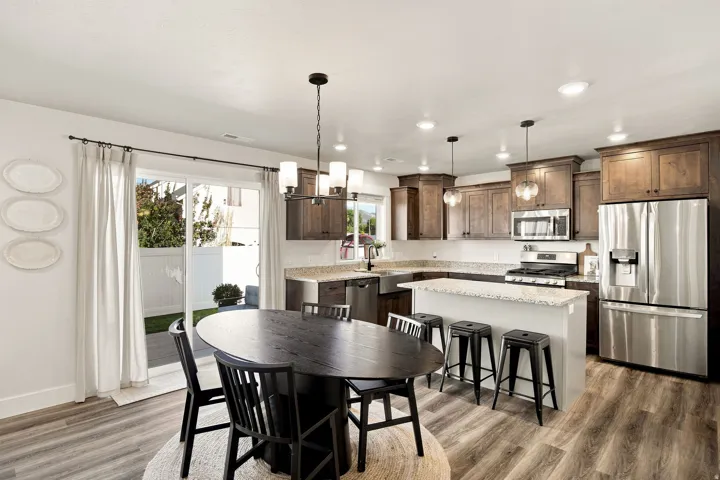 Wood-finish flooring throughout, kitchen with stainless steel appliances, granite countertops, and dark wood cabinetry