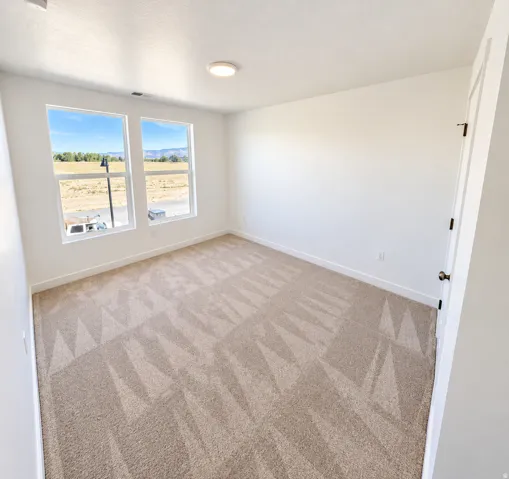 Recessed lighting, wall-to-wall carpeting, and bright white walls