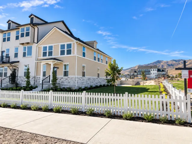 Light-colored siding exterior with dark trim accents