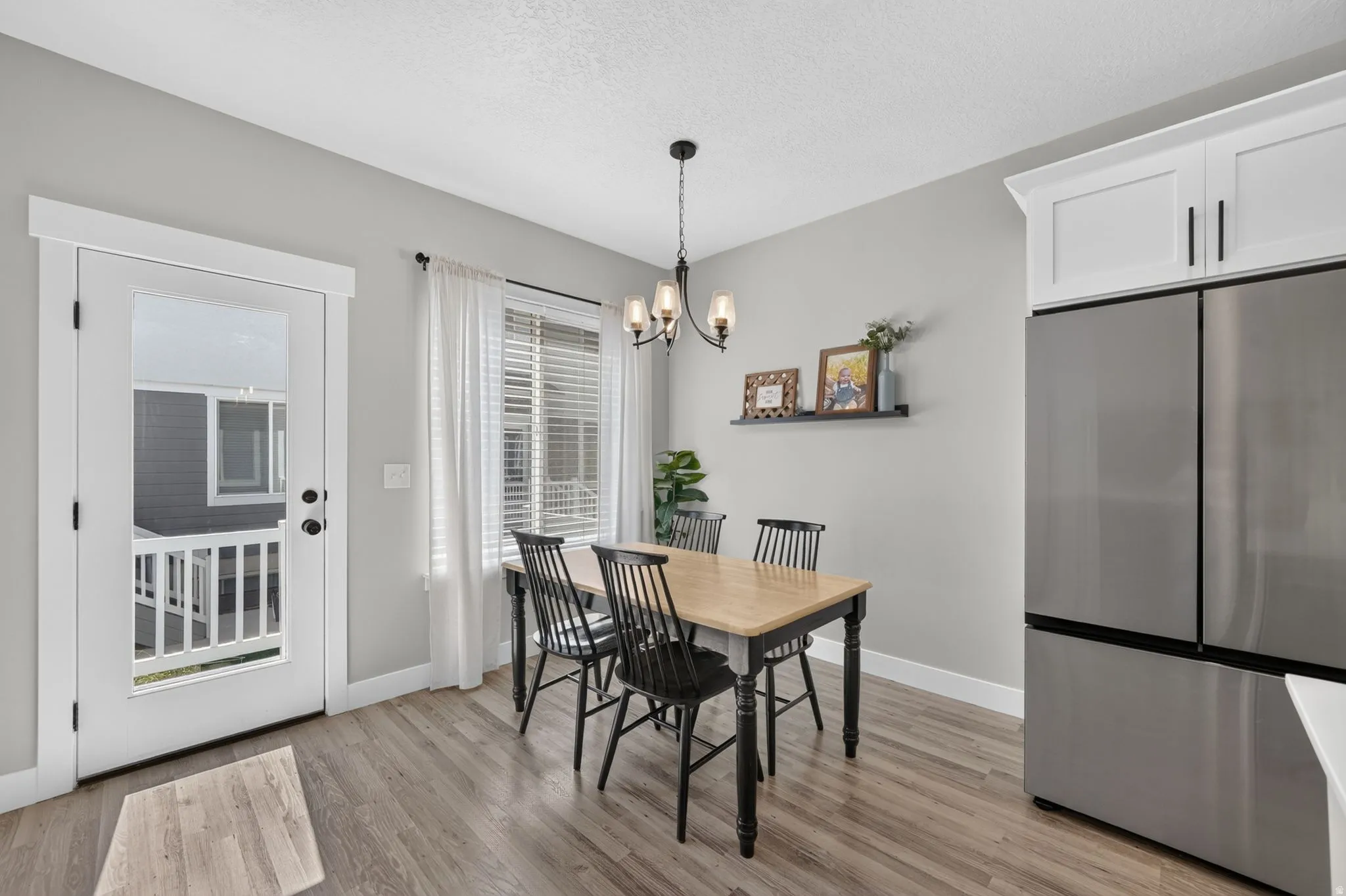 Wood-finish flooring with light gray walls and white trim