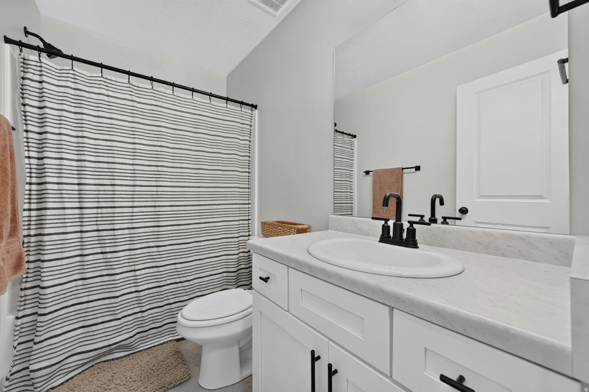 White vanity featuring shaker-style cabinetry