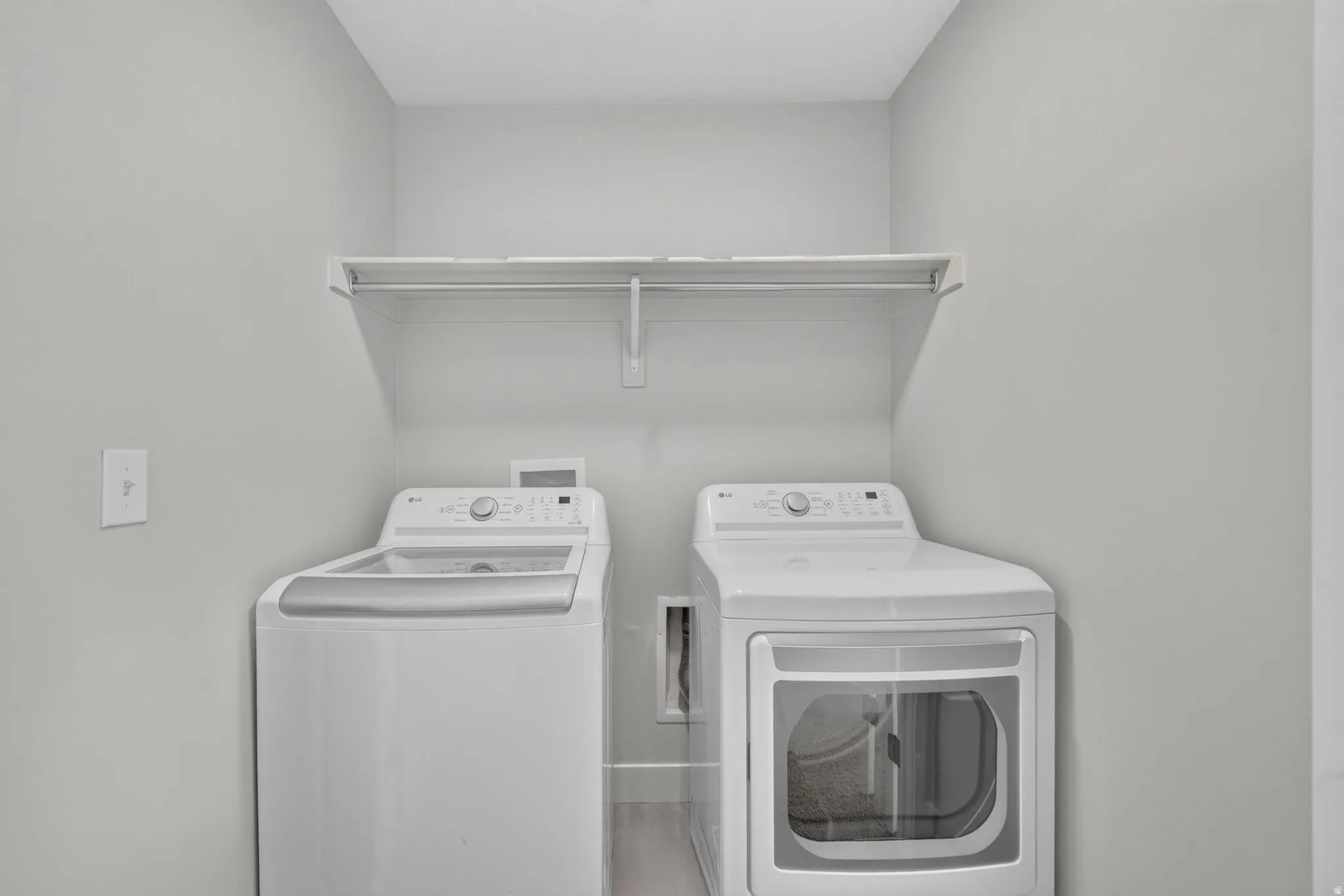Dedicated laundry area with a white wire shelving unit