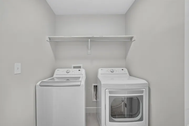 Dedicated laundry area with a white wire shelving unit