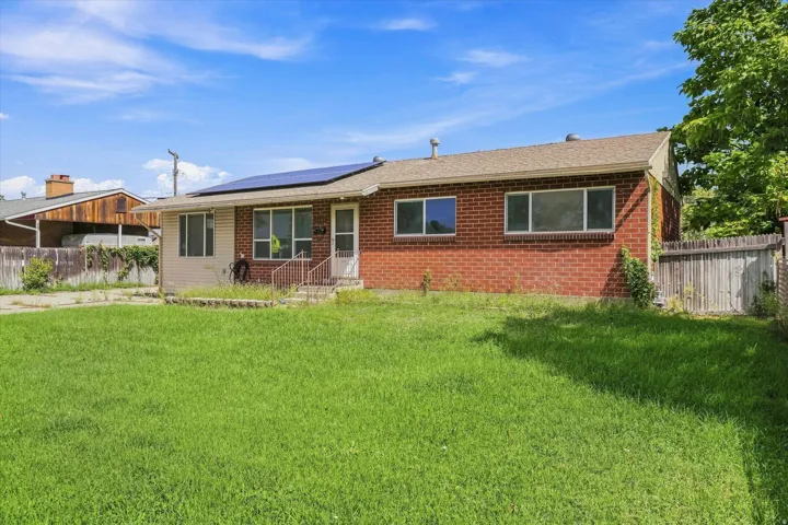 Brick and siding exterior with a pitched shingle roof