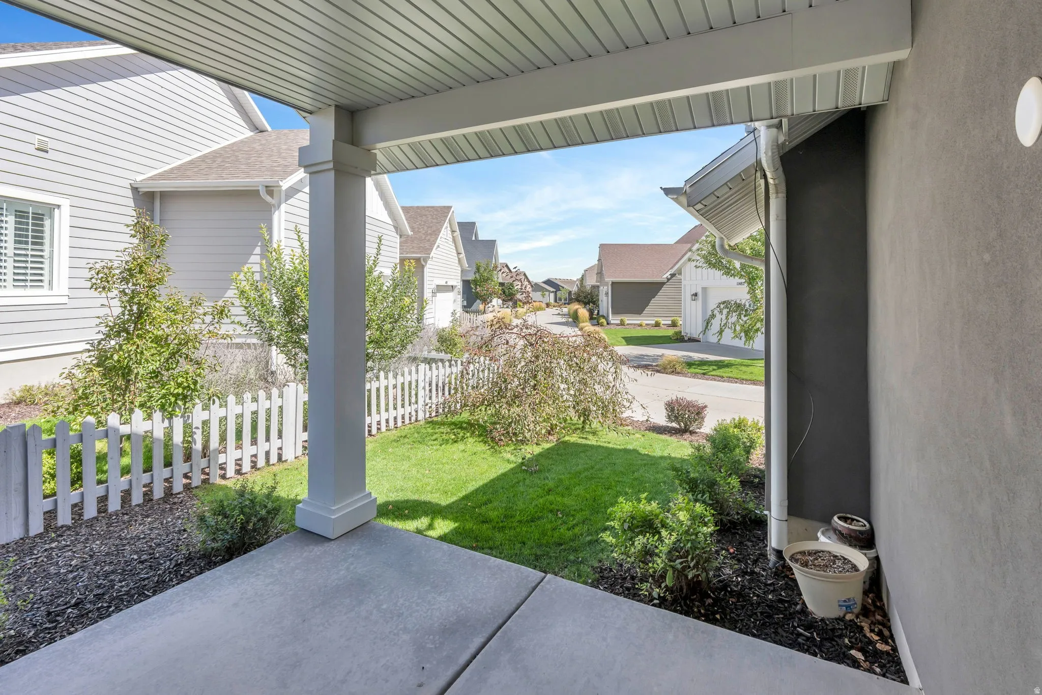 Covered porch with concrete flooring and white column