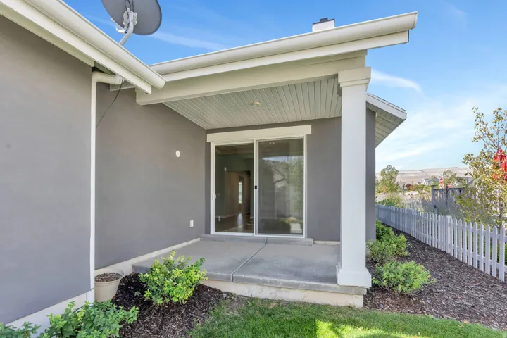 Concrete patio with a covered overhang and a sliding glass door