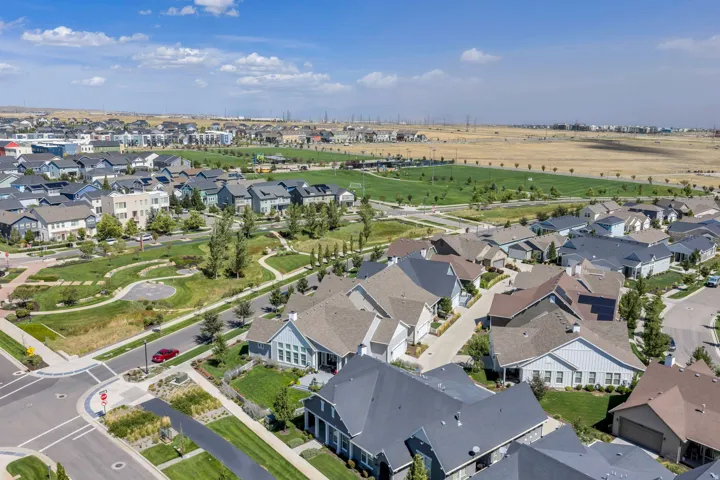 Community featuring residential architecture, green spaces, and a large recreational field