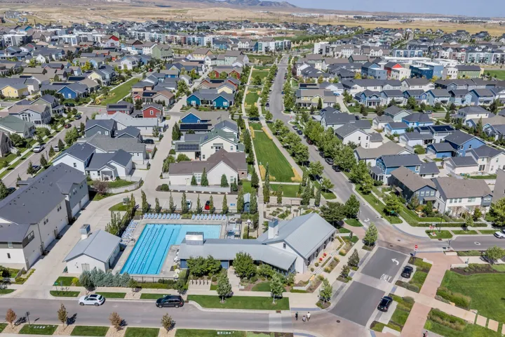 Aerial perspective of a developed residential community featuring varied architectural styles and mature landscaping