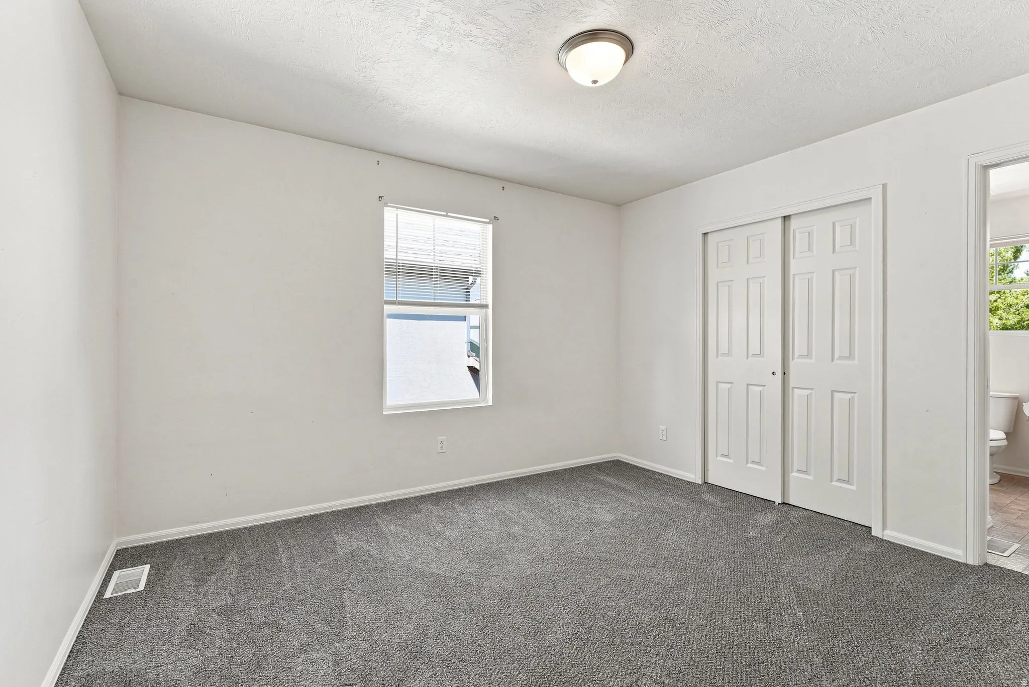 Neutral gray carpeting and white painted walls