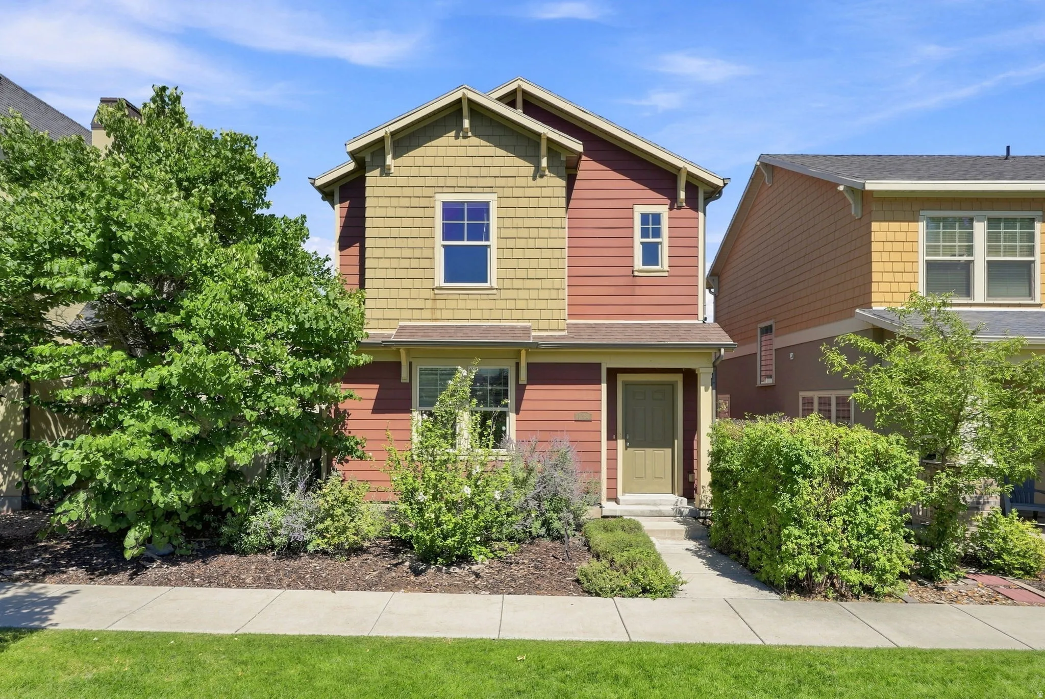 Two-story residence featuring composite siding and shingle accents