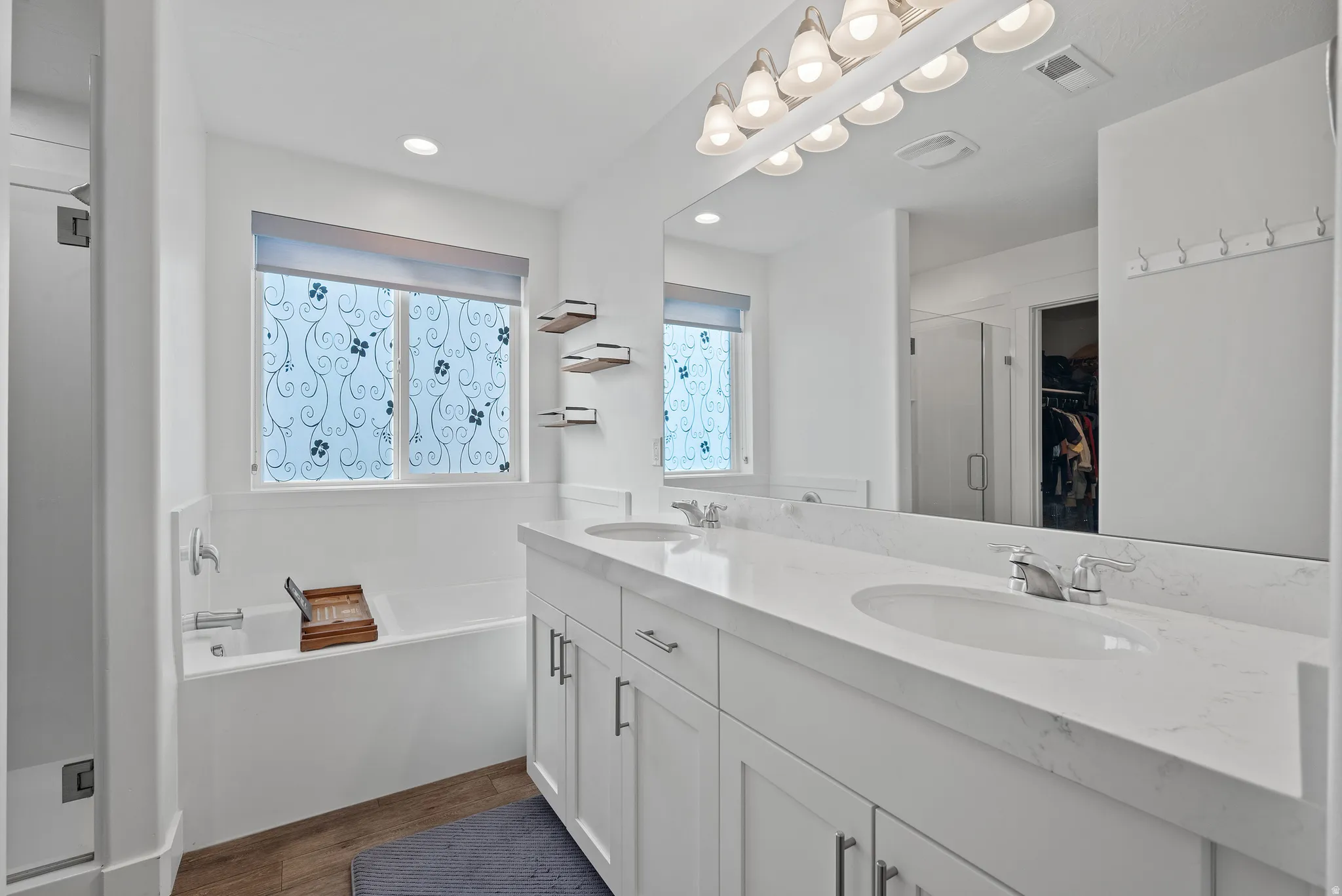 Dual vanity with undermount sinks and light-toned countertops